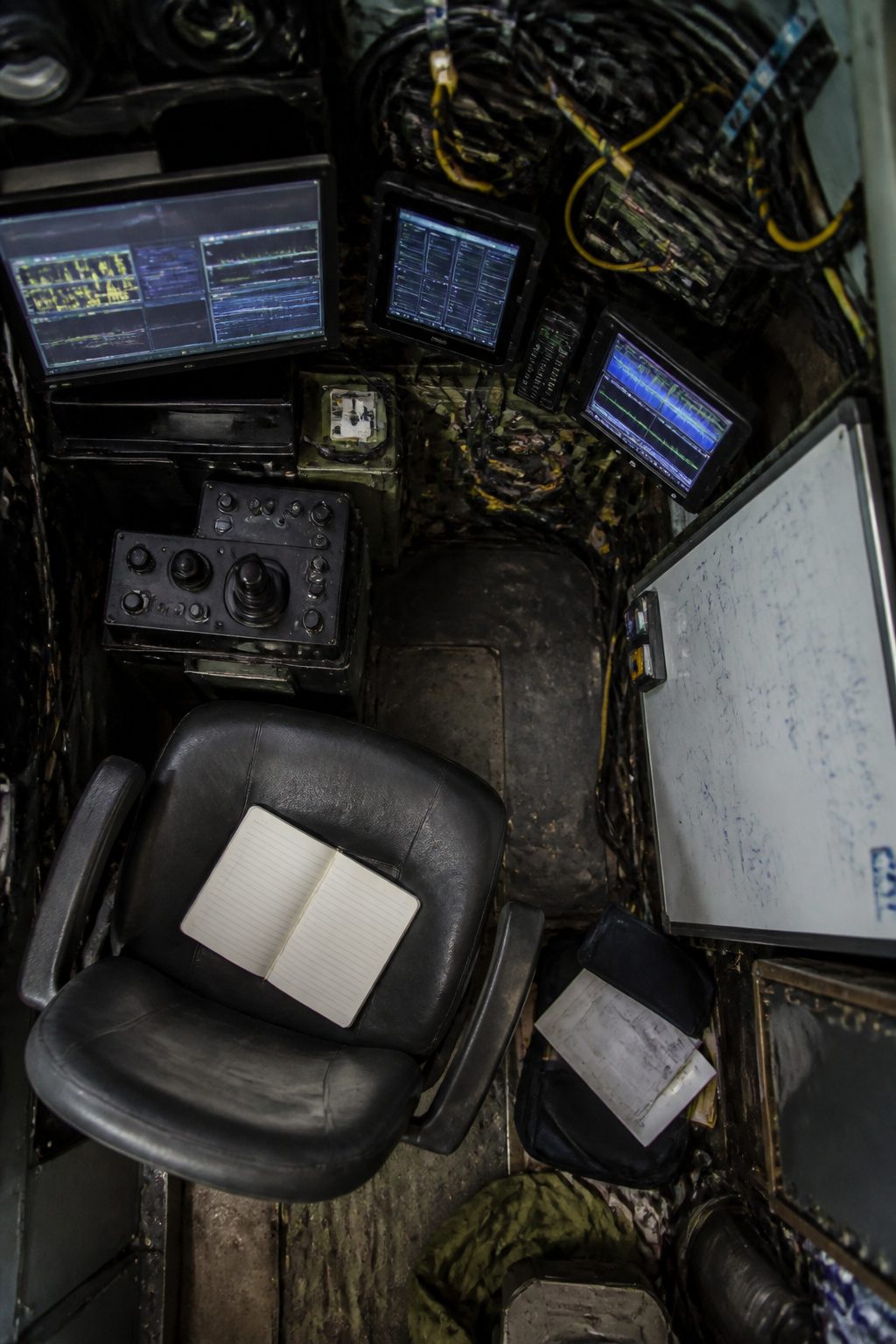 A cluttered workspace shows papers and notes, reflecting cognitive load.