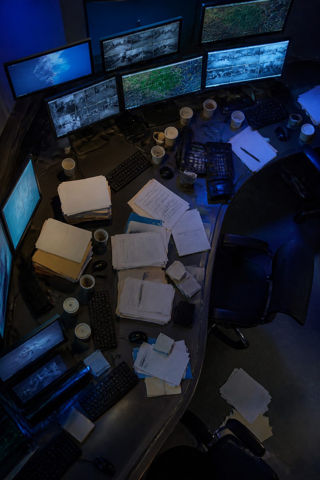 A crowded scene shows a responder surrounded by various equipment and tasks.