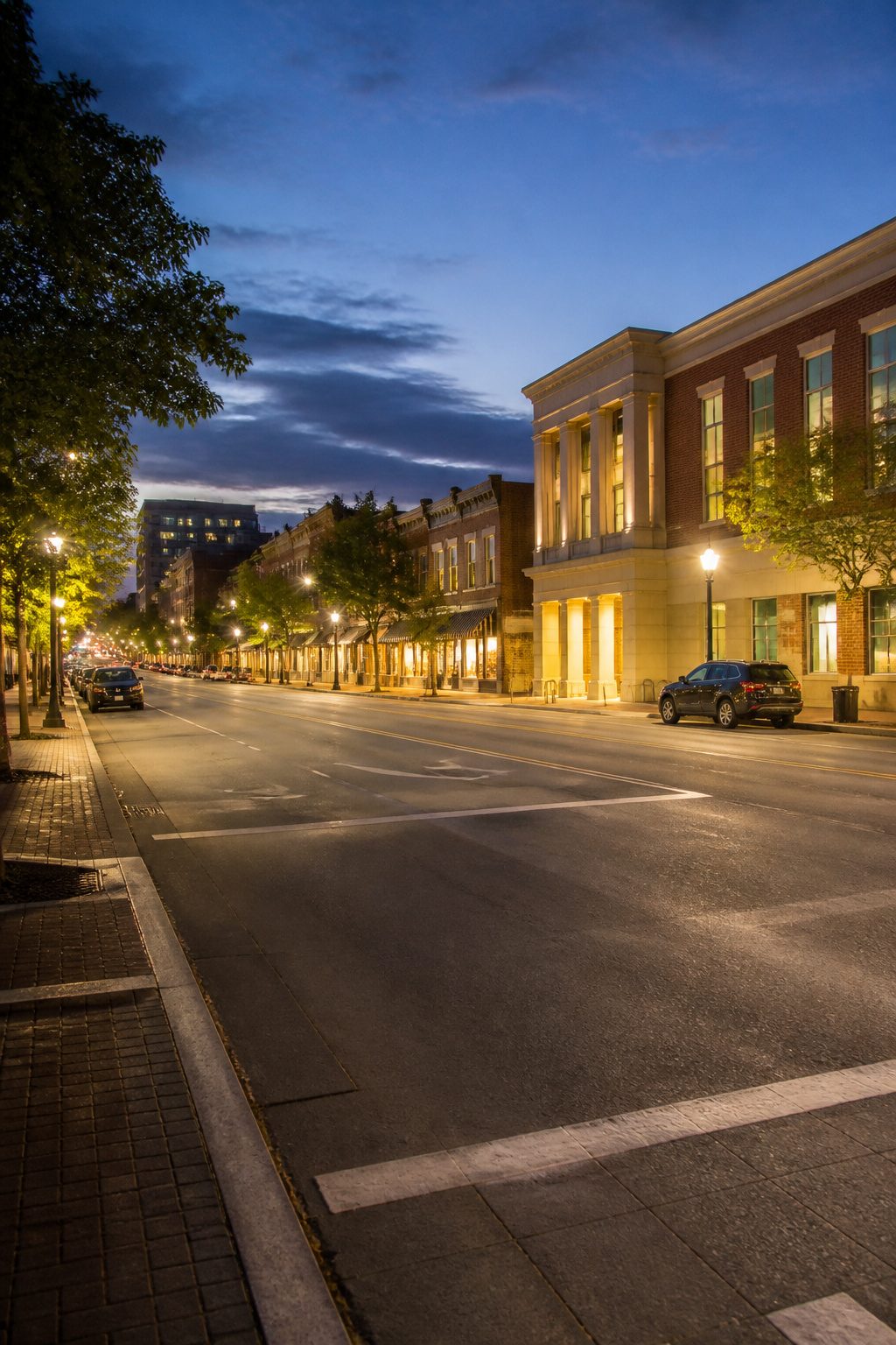 A busy street scene with well-lit sidewalks and people walking.