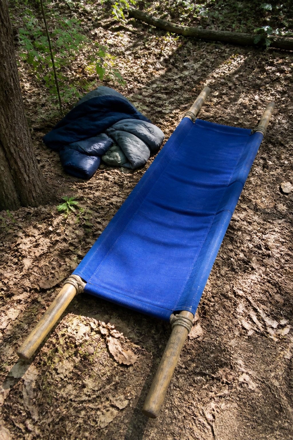 Emergency Preparedness Merit Badge 16 An improvised stretcher made with wooden poles and a blanket.