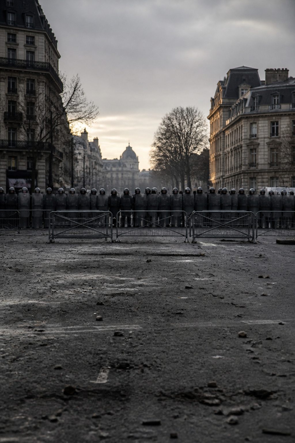 How to Escape a Riot: 9 Steps to Get Out Safely (2026) 13 A police line during a riot with officers holding shields.