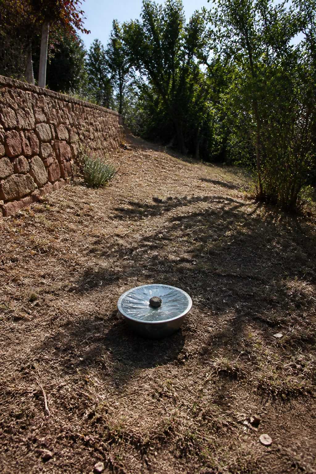 How to Make a Solar Still: Seven Steps for Clear Water 7 A solar still setup positioned under sunlight with a clear view of the ground.