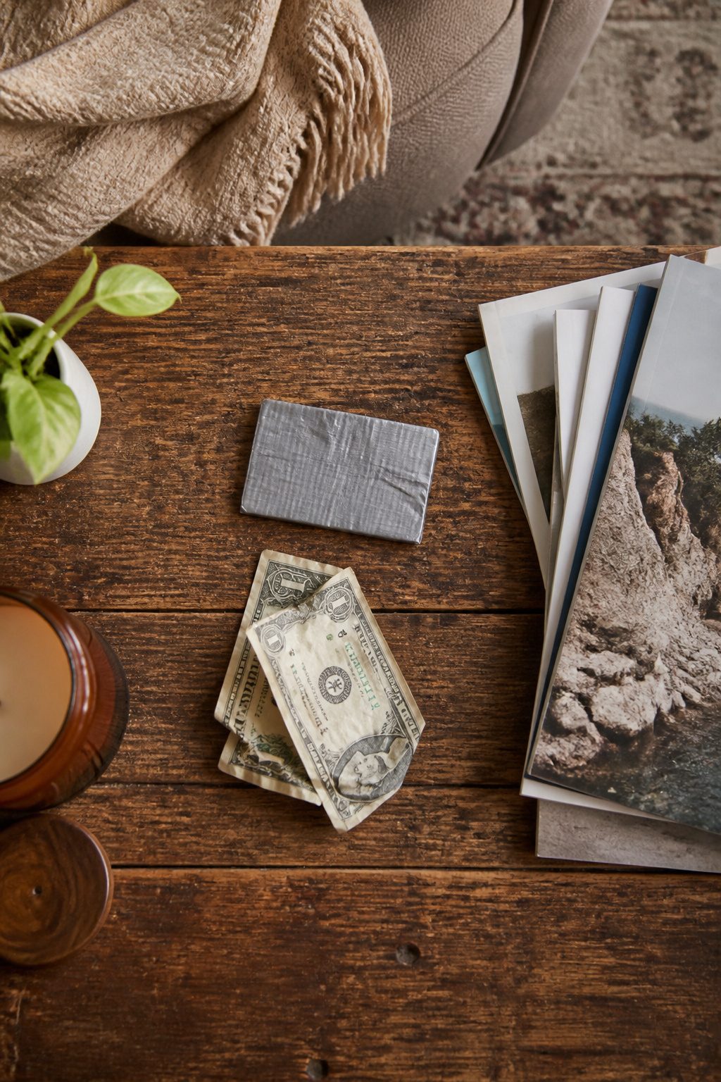 How to Make a Survival Kit: Emergency Preparedness Guide 12 A roll of duct tape and a stack of cash on a table.