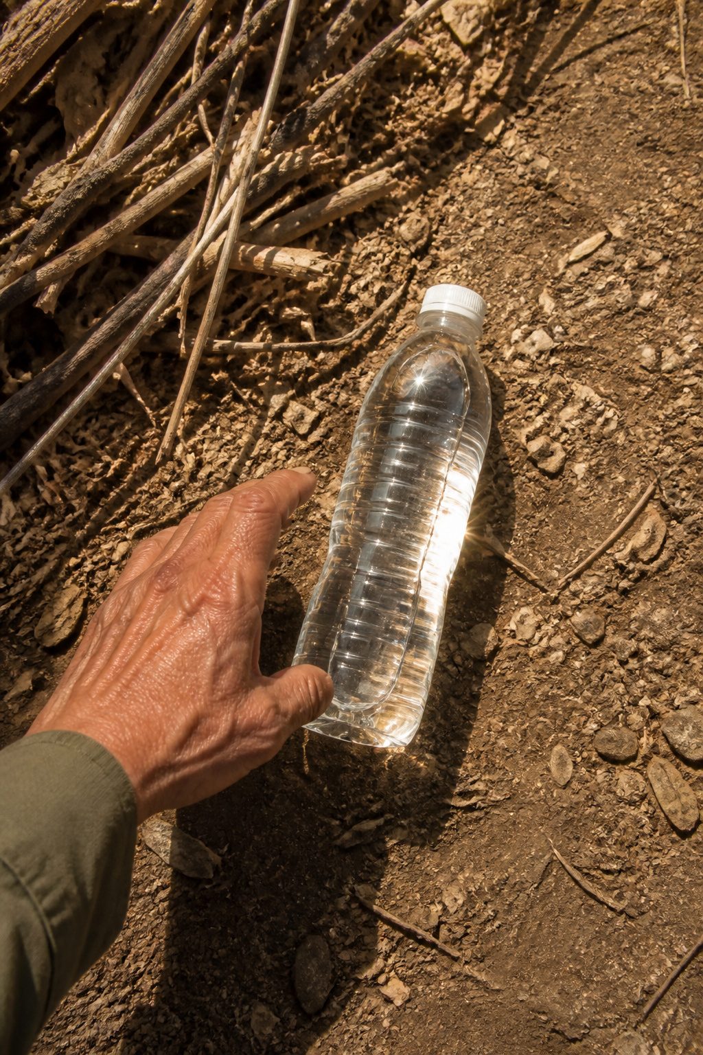 Clear PET bottles marked with recycle code #1 on a table.