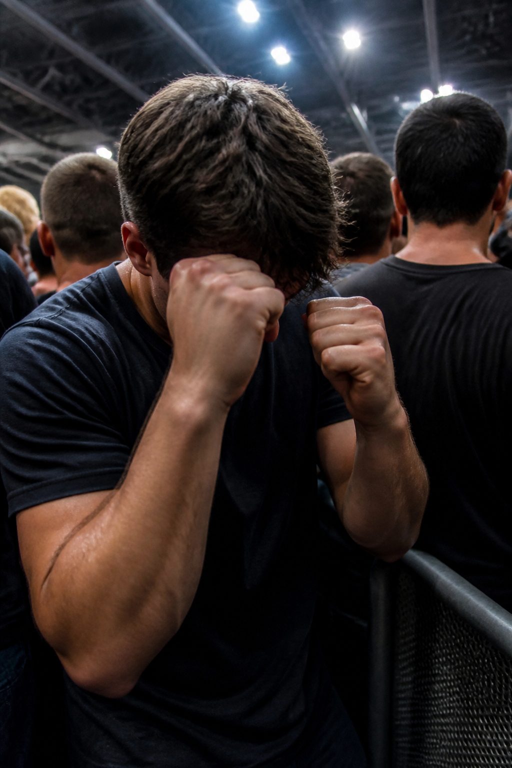 How to Survive a Stampede: 8 Steps for Escaping a Deadly Crowd (2026) 4 A person with arms raised in a crowded space, illustrating protection.