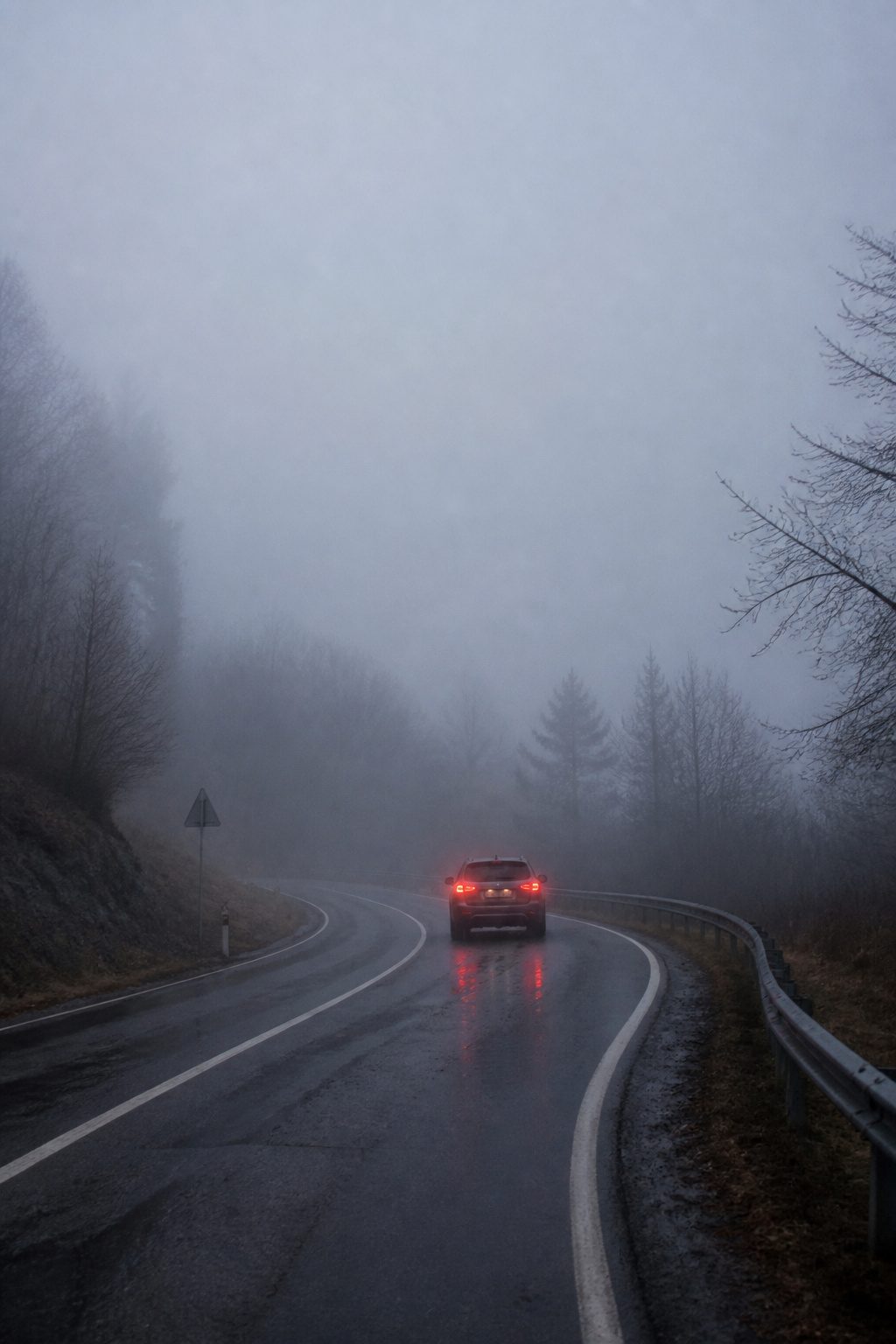 Safety Tips for Driving in the Fog: 9 Ways to Stay Safe in 2026 7 A car slowly braking in a foggy environment.