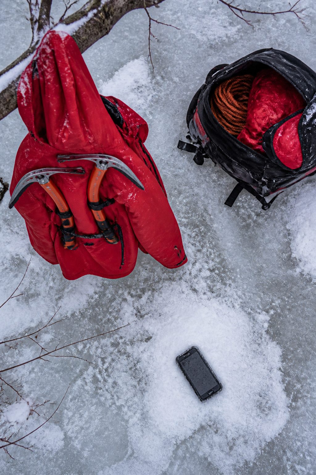 A person wearing ice picks around their neck while standing on a frozen lake.